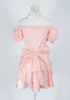 Blush pink girly dress with big bow and ruffles